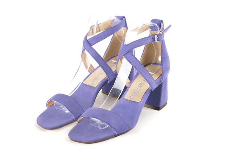  elegant sandals with crossed straps across the instep, closed at the back. . .